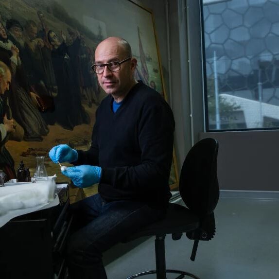 NGV's head of conservation Michael Varcoe-Cocks working on the painting The Pilgrim Fathers.CREDIT:SIMON SCHLUTER