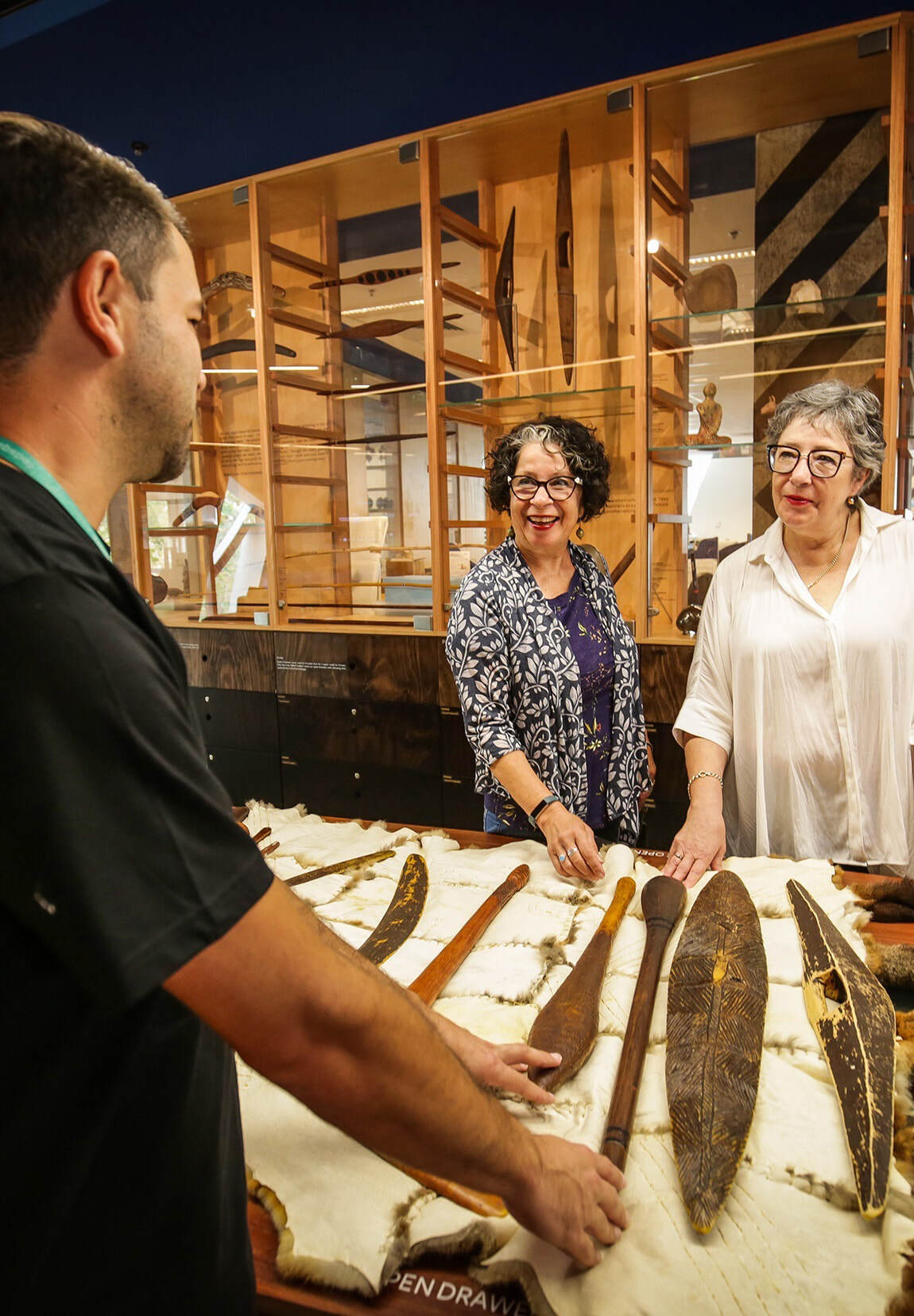 KHT tour guide with 2 guests around the canoe table at the Koorie Heritage Trust. Photo Nicole Cleary crop