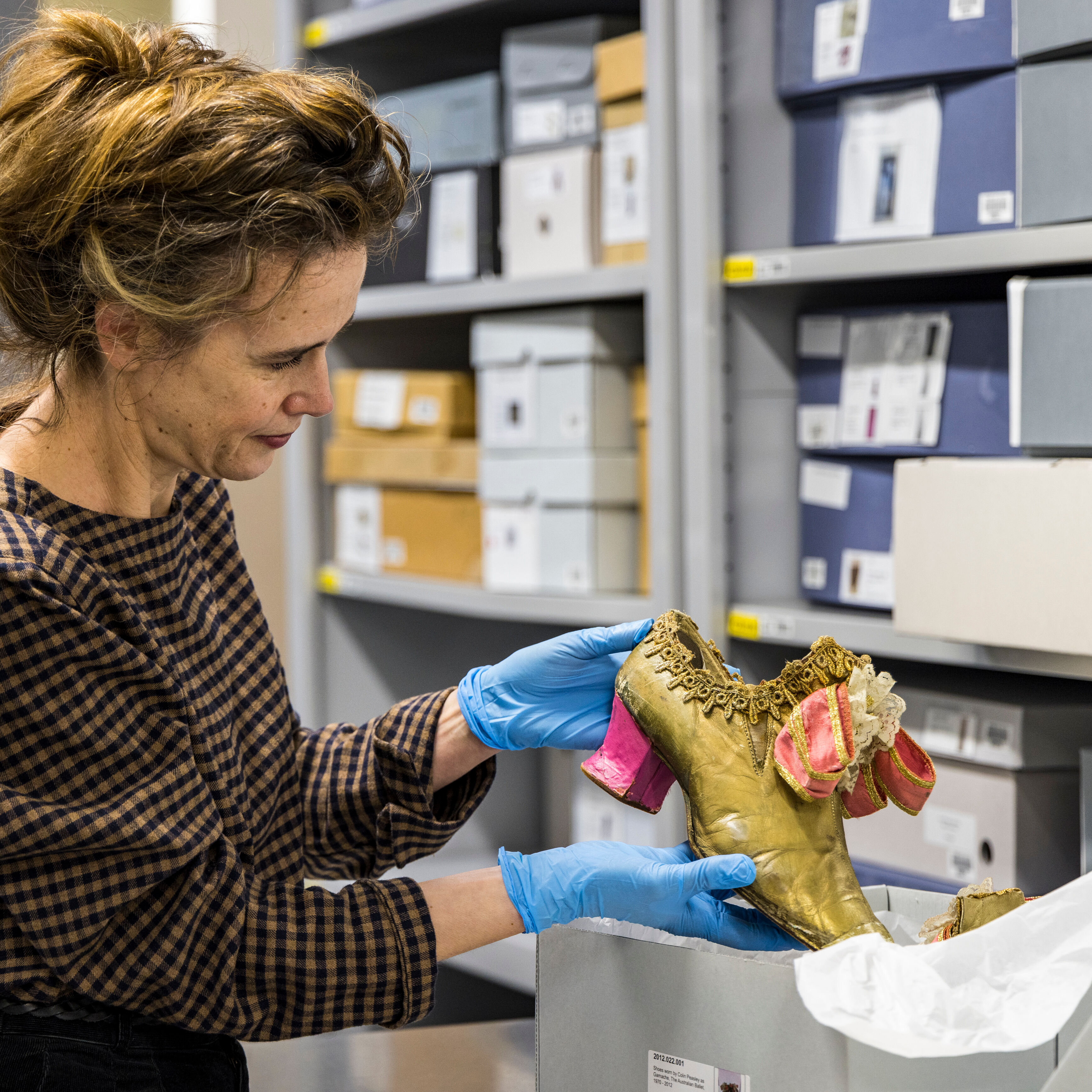 Curator Margot Anderson with shoes from Don Quixote. Photographer Mark_Gambino